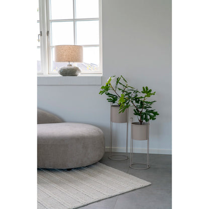 Lampe de table Oldham en céramique verte allumée sur une table d'appoint moderne