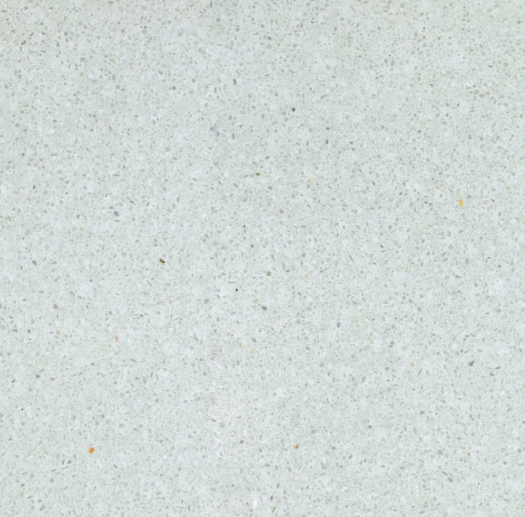 Carrelage microterrazzo Vert Brume au fond gris-vert très pâle, ponctué de fins granulats minéraux, pour revêtement de sol et mur.